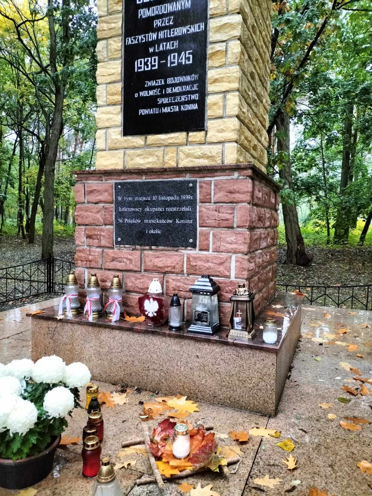 pomnik w parku znicz na podstawie z liści zrobionej przez dzieci 