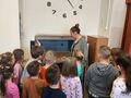 dzieci z bibliotekarka przy windzie na książki