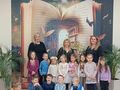 grupa dzieci na tle fototapety z otwartą książką